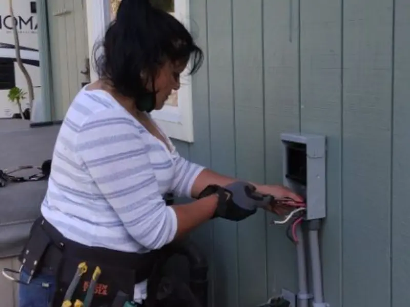 Licensed electrician wiring an exterior subpanel in Ashland